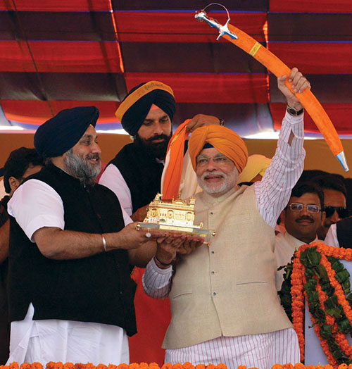 Modi, prime ministerial candidate for India's main opposition BJP, is presented with a sword and a memento by Punjab deputy Chief Minister Badal during a rally at Jagraon in Ludhiana