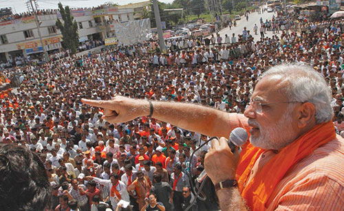 Gujarat's CM Modi addresses his supporters during an election campaign rally ahead of the state assembly elections at Dokar village in Gujarat
